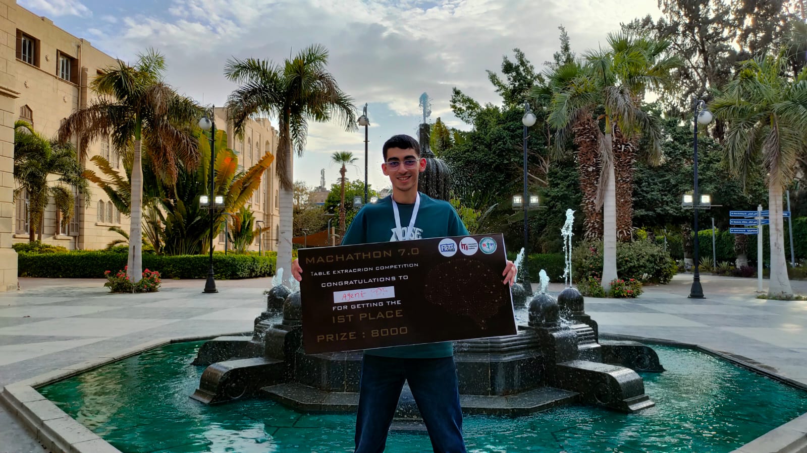 Mohamed Sameh holding the first-place MACHATHON 7.0 Agent P-DF award board